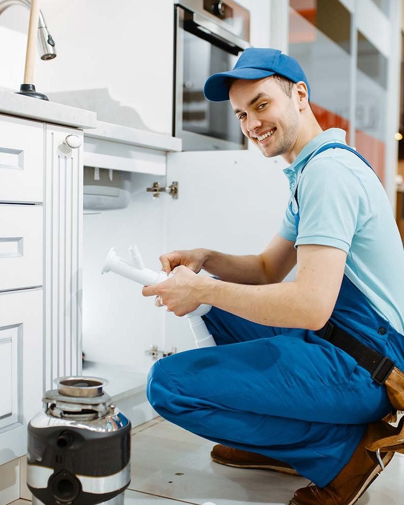 smiling-male-plumber-in-uniform-holds-drain-pipe-resize.jpg smiling-male-plumber-in-uniform-holds-drain-pipe-resize.jpg